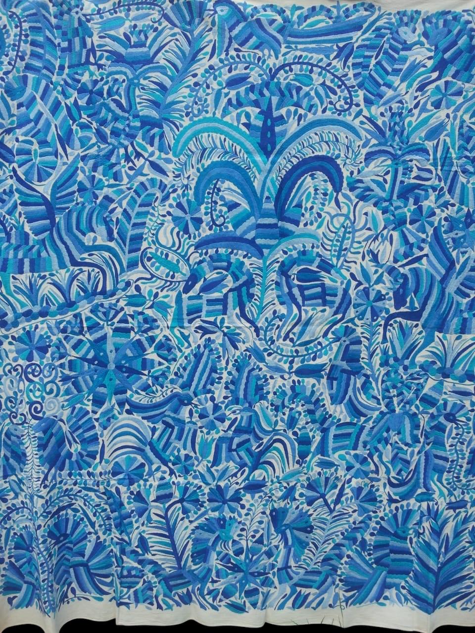 Extra large all blue Otomi tapestry wall art hand-embroidered in Mexico, depicting various patterns and scenes.