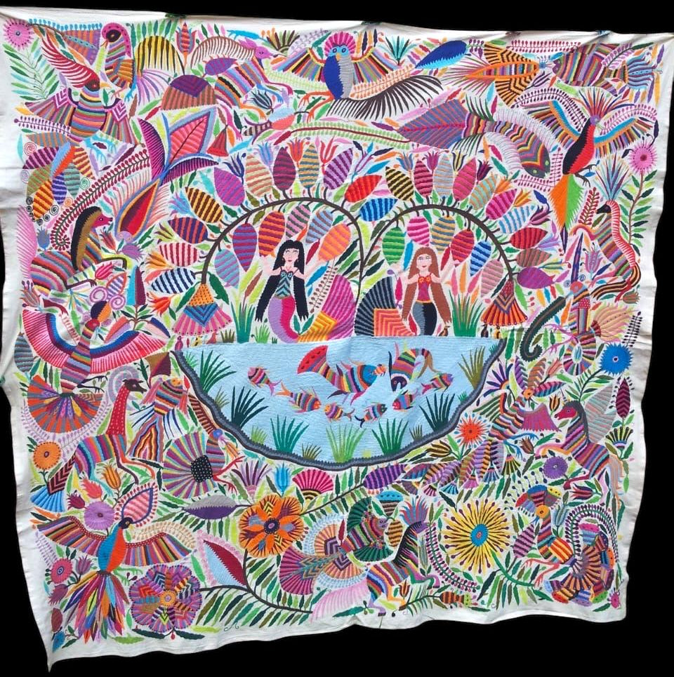 Extra large Otomi tapestry wall art hand-embroidered in Mexico. Featuring colorful floral patterns and mermaid motifs.
