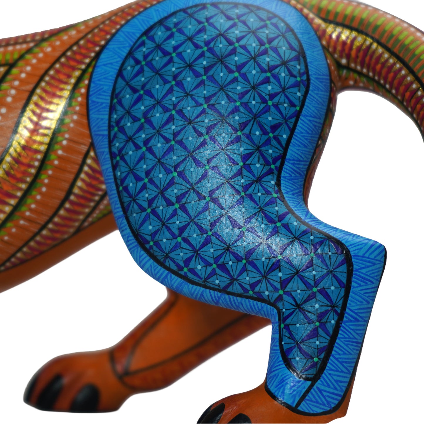 Colourful alebrije jaguar sculpture, close up, with intricate hand-painted patterns, on a white background.