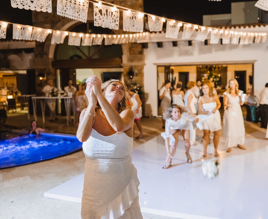 white papel picado wedding bunting; throwing of the bouquet