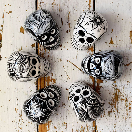 black and white ceramic skulls Dia de Muerto decorations