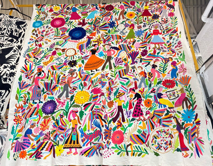Extra large Otomi tapestry wall art hand-embroidered in Mexico, featuring vibrant colors and intricate designs with floral and figurative motifs.