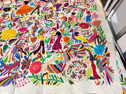 Colorful traditional Otomi hand embroidered Mexican tapestry with intricate patterns and vibrant colors.