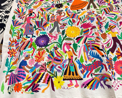 Colorful traditional Otomi hand embroidered Mexican tapestry with intricate patterns and vibrant colors.