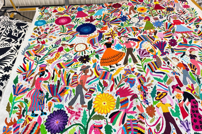 Colorful traditional Otomi hand embroidered Mexican tapestry with intricate patterns and vibrant colors.