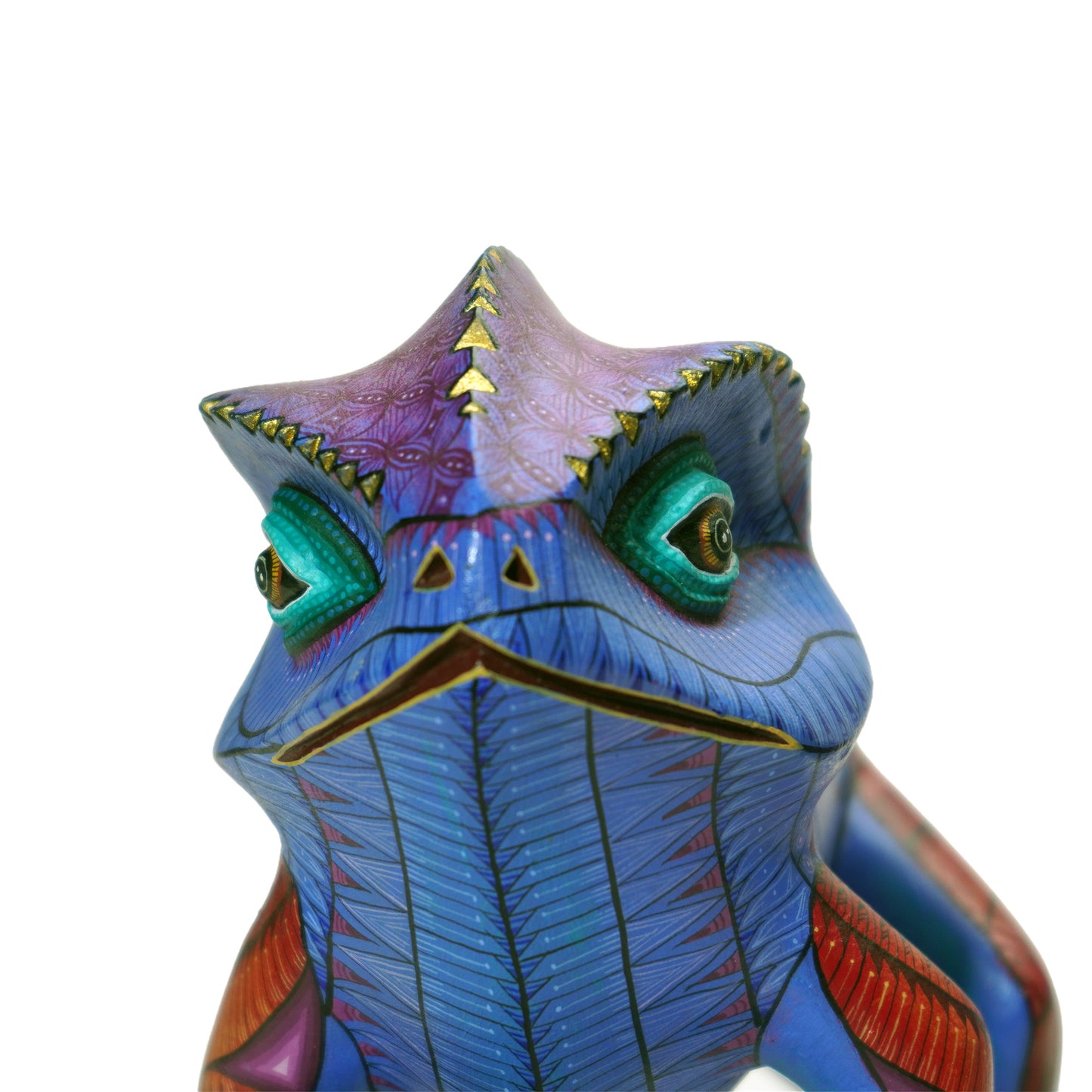 Colorful chamelion art figurine with detailed design on a white background. Mexican alebrije animal sculptute.