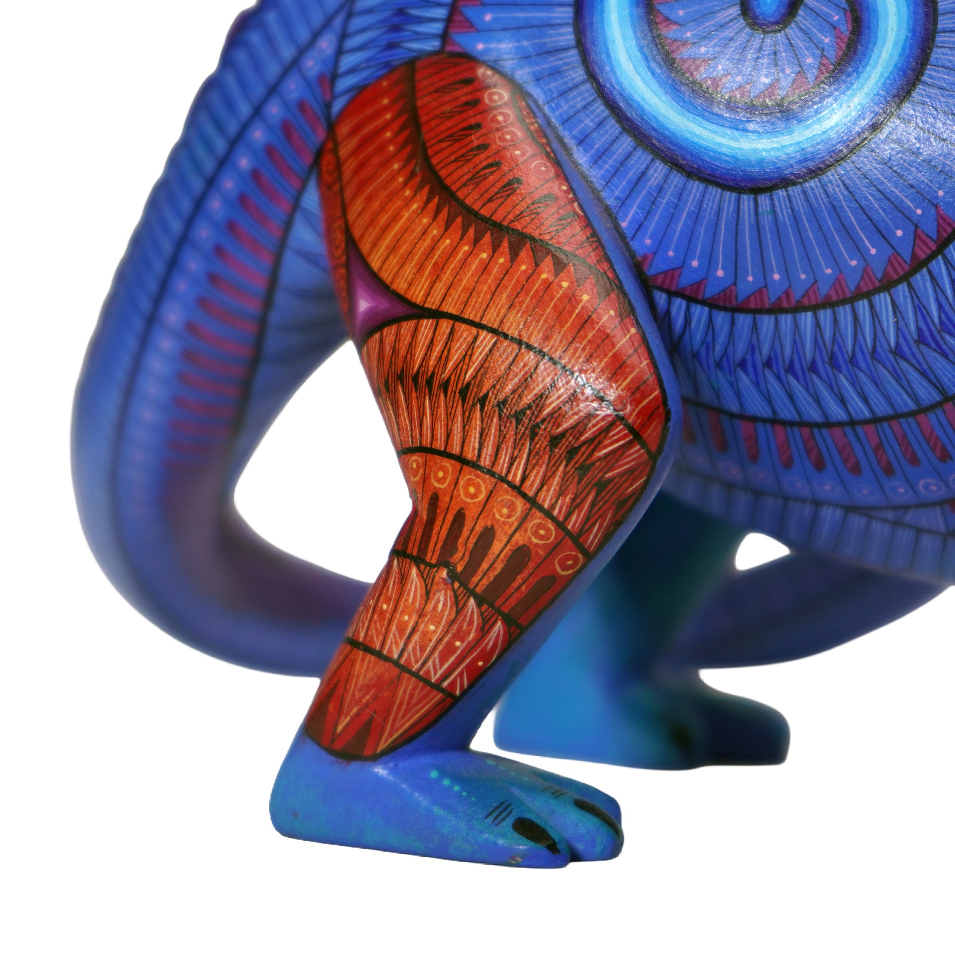 Colorful abstract sculpture with blue, red, and purple patterns on a white background.