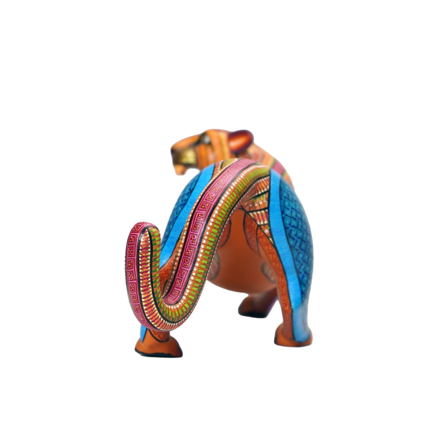 The back view of a colourful alebrije jaguar sculpture, with intricate hand-painted patterns, on a white background.