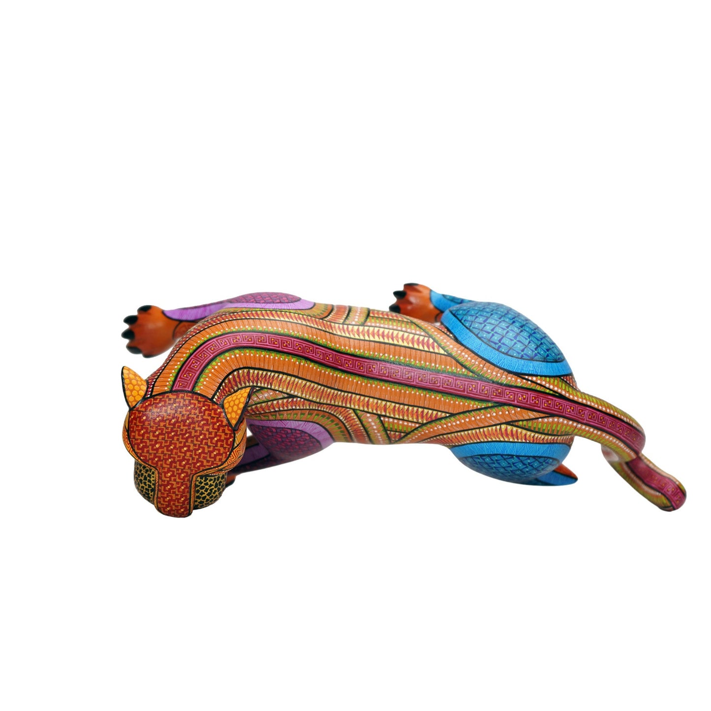View from above of a colourful alebrije jaguar sculpture, with intricate hand-painted patterns, on a white background.
