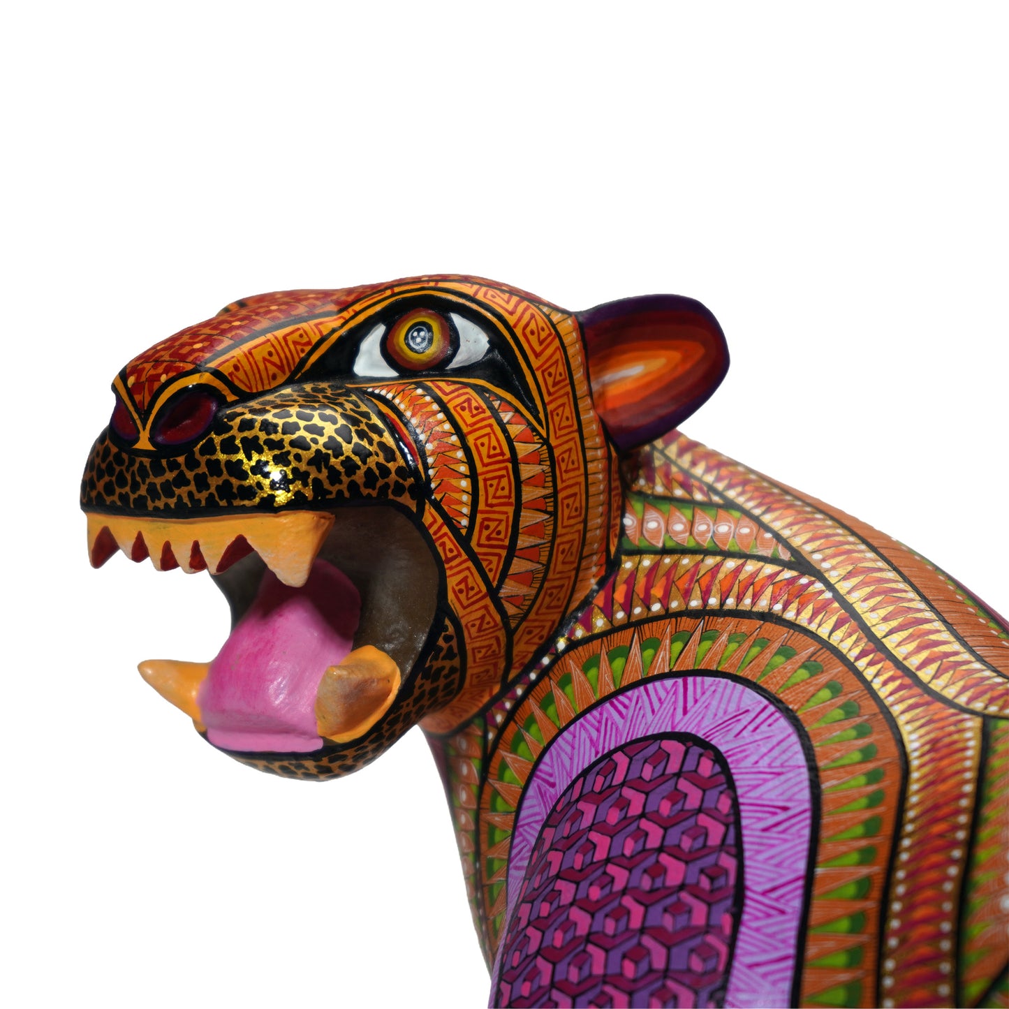 Colourful alebrije jaguar sculpture, close up, with intricate hand-painted patterns, on a white background.