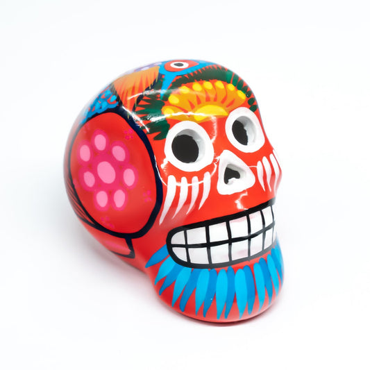 Colourful red skull with hand-painted design, on a white background