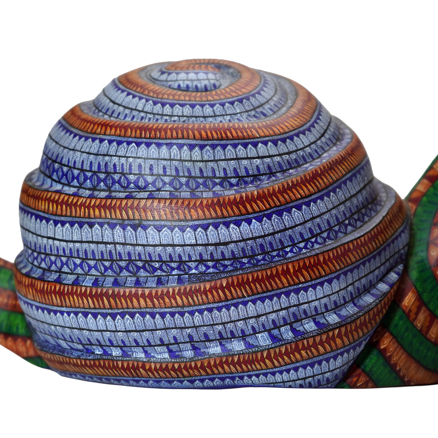 Decorative Oaxacan wood carving with blue and orange patterns on a white background.