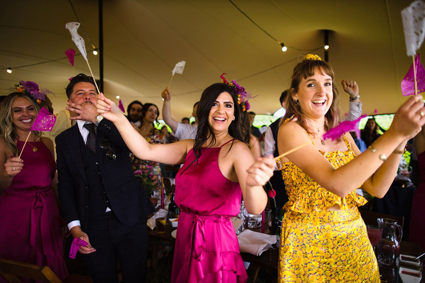 Wedding guests waving colorful flag favour decorations.