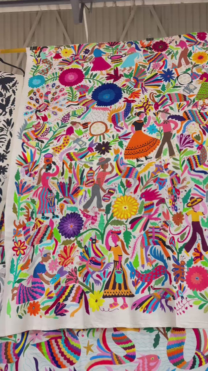 Colorful traditional Otomi hand embroidered Mexican tapestry with intricate patterns and vibrant colors.
