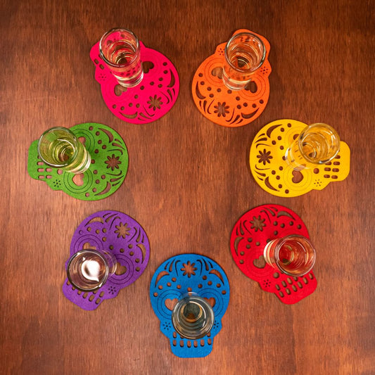 set of 7 differently coloured skull shaped drinks coasters